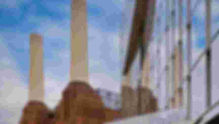 The new development at Battersea Power Station reflected in the windows of an adjacent skyscraper. Credit: Paul Hayward / Alamy Stock Photo.
