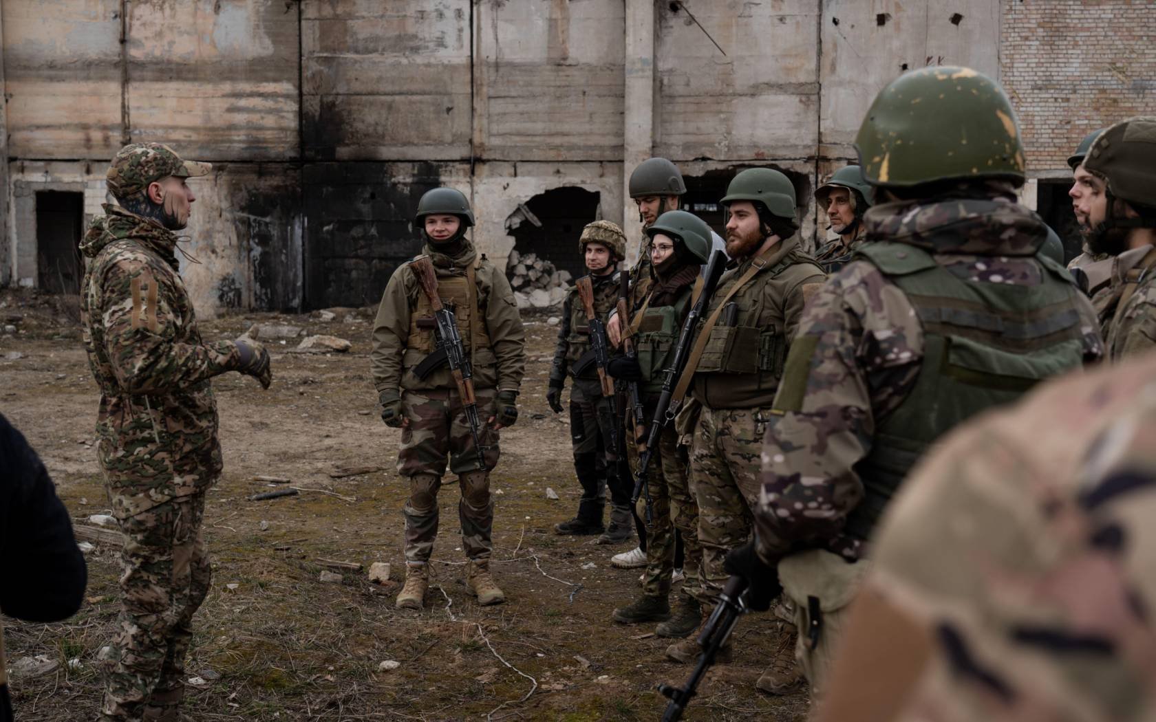 A group of trainees listens to the military instructor in a training organised by the third separate assault brigade in Kyiv, Ukraine.