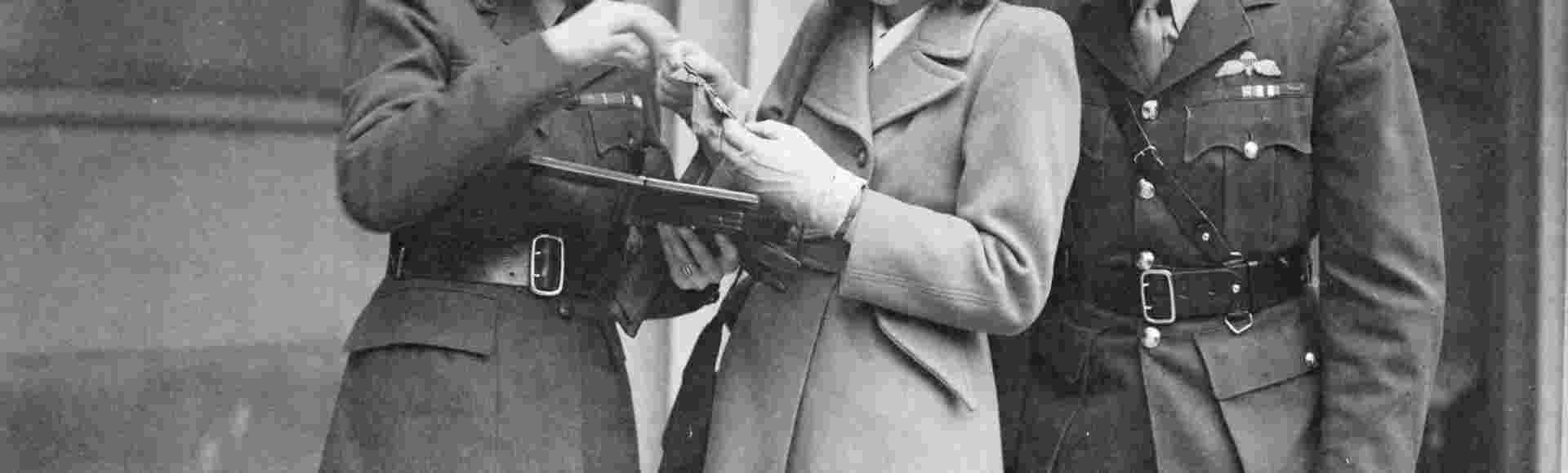 Mrs Odette Sansom showing her George Cross medal to her daughter François after the investiture ceremony at Buckingham Palace, on 19 November 1946.
