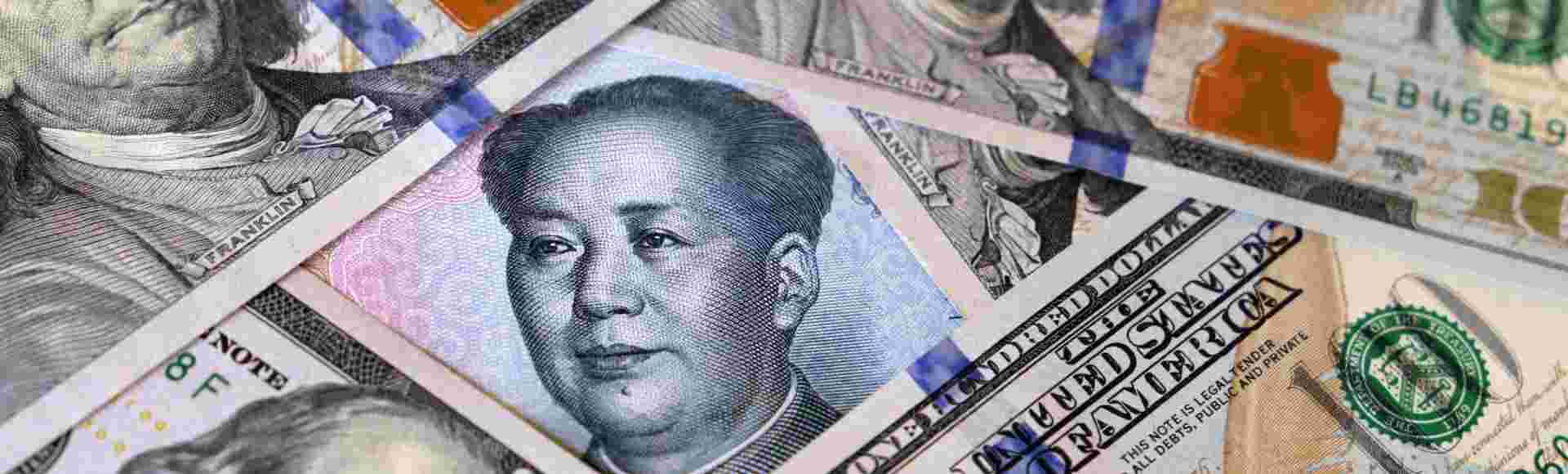 Chinese yuan surrounded by US dollar bills.