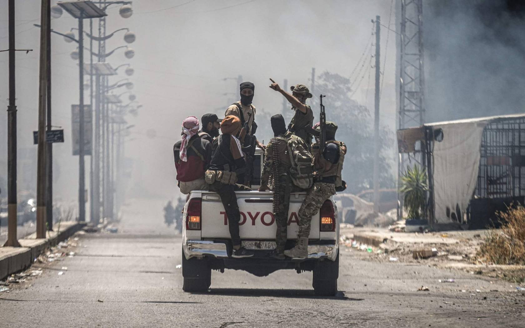 Bedouin and tribal fighters gather in a vehicle in the city of Suwayda.