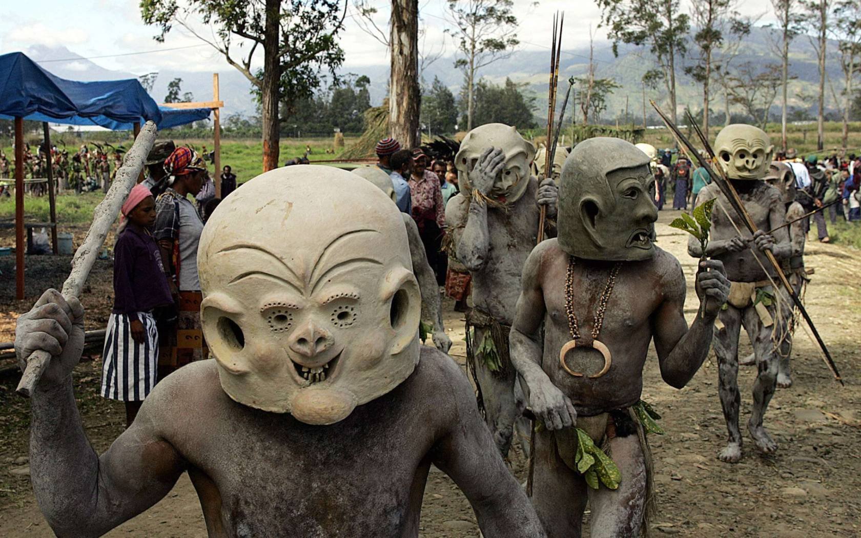 Asaro mud men from Goroka walk to the annual sing-sing cultural festival in Mount Hagen in 2004. Over 70 tribes put aside their ethnic tensions to come together once a year in the remote frontier town to celebrate the cultural diversity of Papua New Guinea.