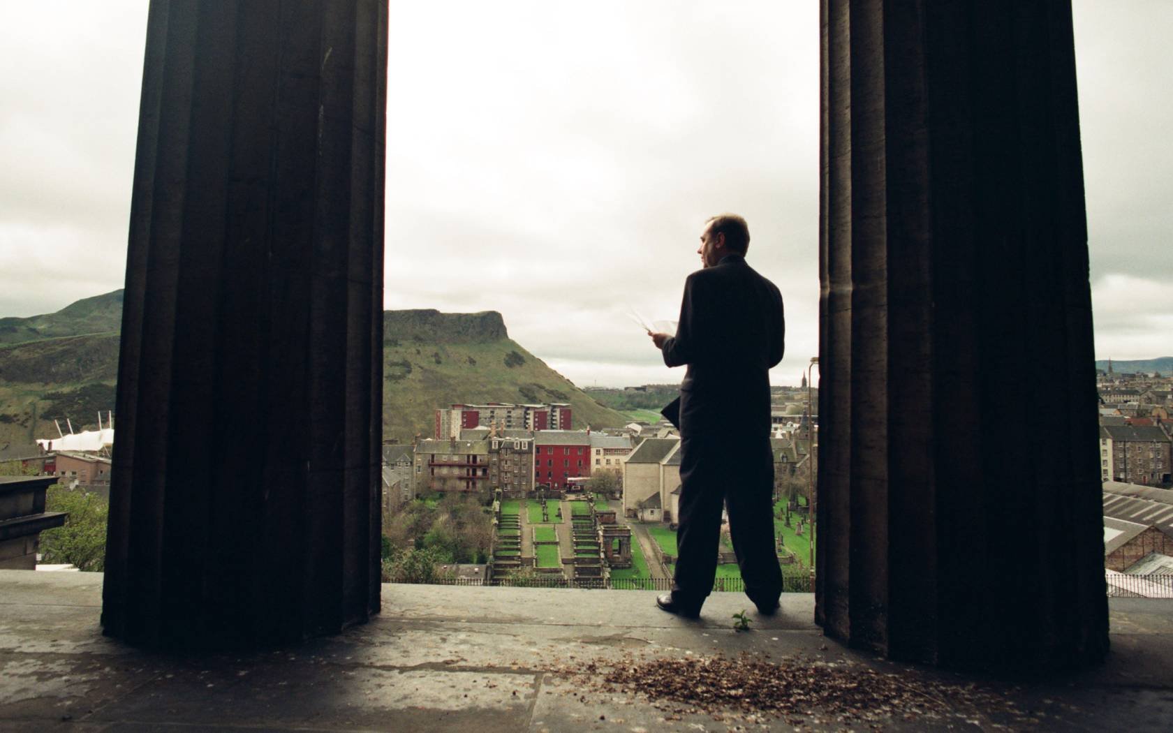 Alex Salmond poses for photographs with a copy of the SNP's 1999 election manifesto at the former Royal High School building in Edinburgh, Scotland.