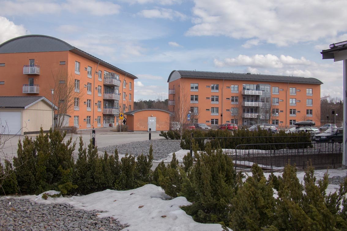 Exterior of two orange buildings with balconies