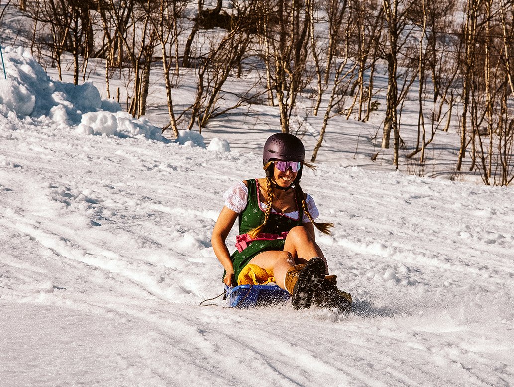 Girl sleds in Tyrolean dress at Rakkas Open