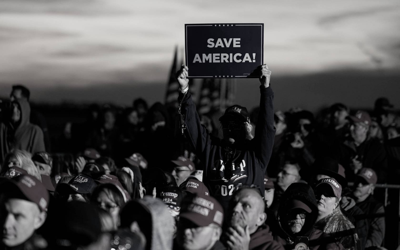 A supporter holds up a sign at a rally for Donald Trump and J.D. Vance.