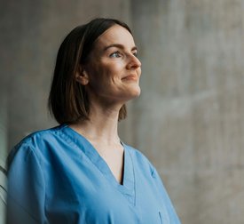 Smiling beautiful female medical professional with short hair looking away