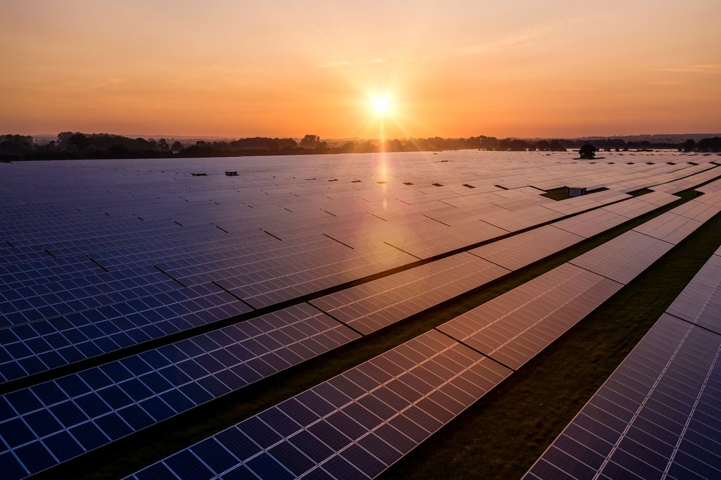 Sunrise over a modern solar farm
