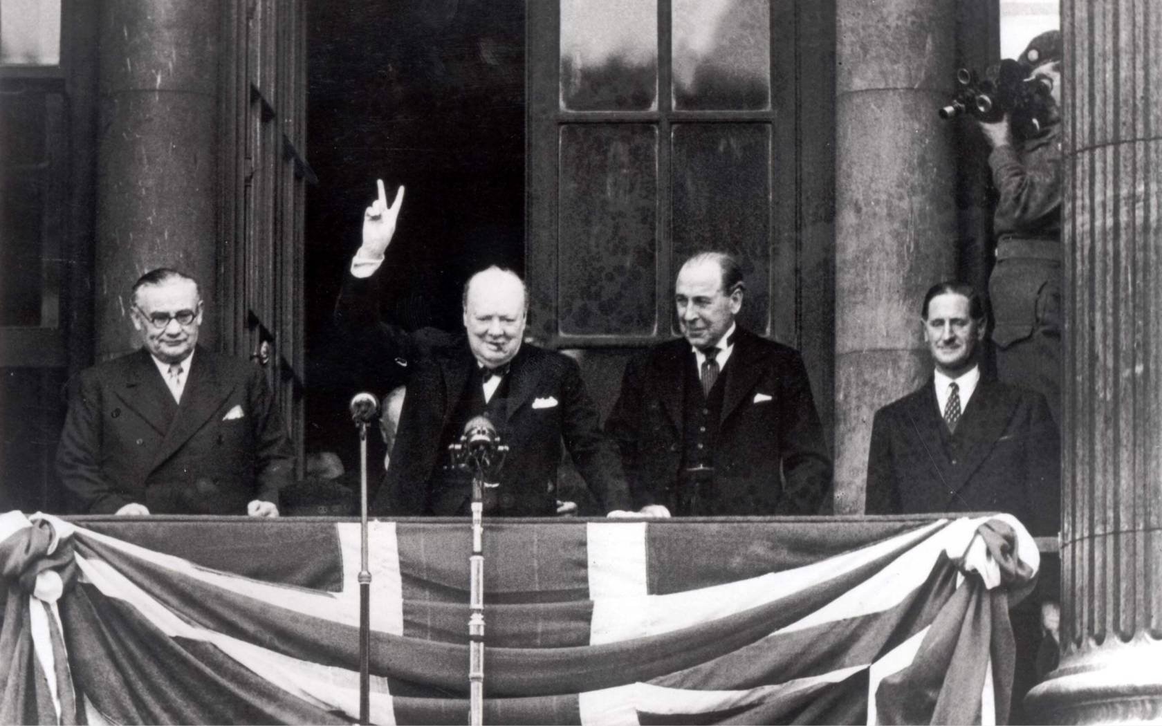 British Prime Minister Winston Churchill addresses the crowds from the balcony of the Ministry of Health in Whitehall on VE Day, 8th May 1945