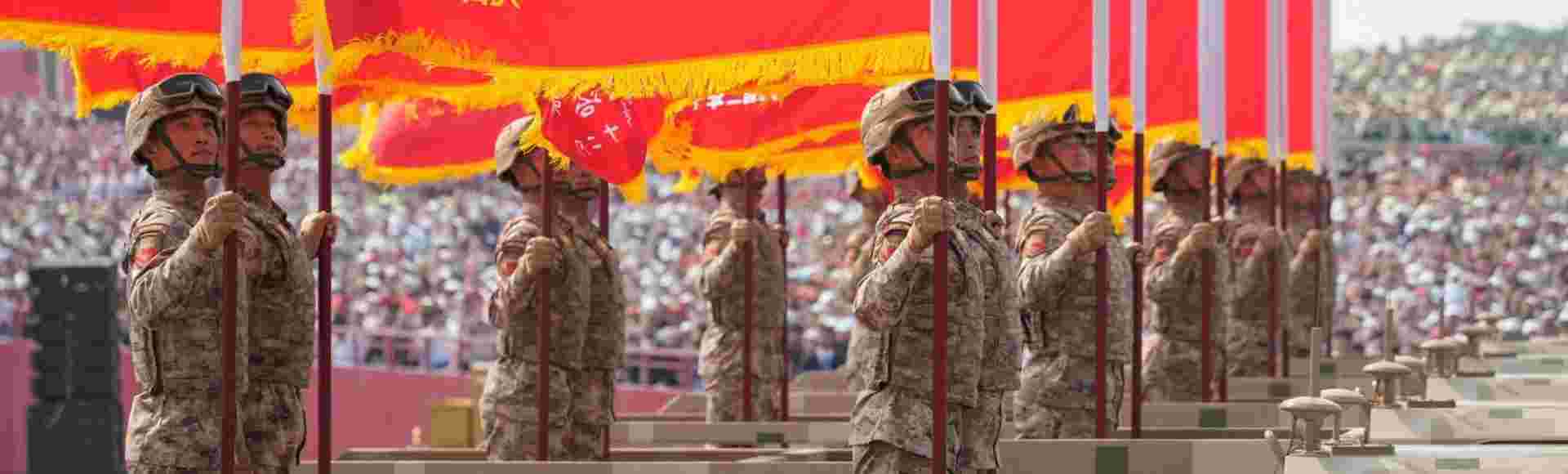Members of the People's Liberation Army (PLA) holding up flags on trucks during a military parade held in front of Tiananmen Gate on September 3, 2025 in Beijing, China.