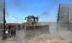 Hamas fighters crossing the border fence with Israel from Khan Yunis in the southern Gaza Strip.