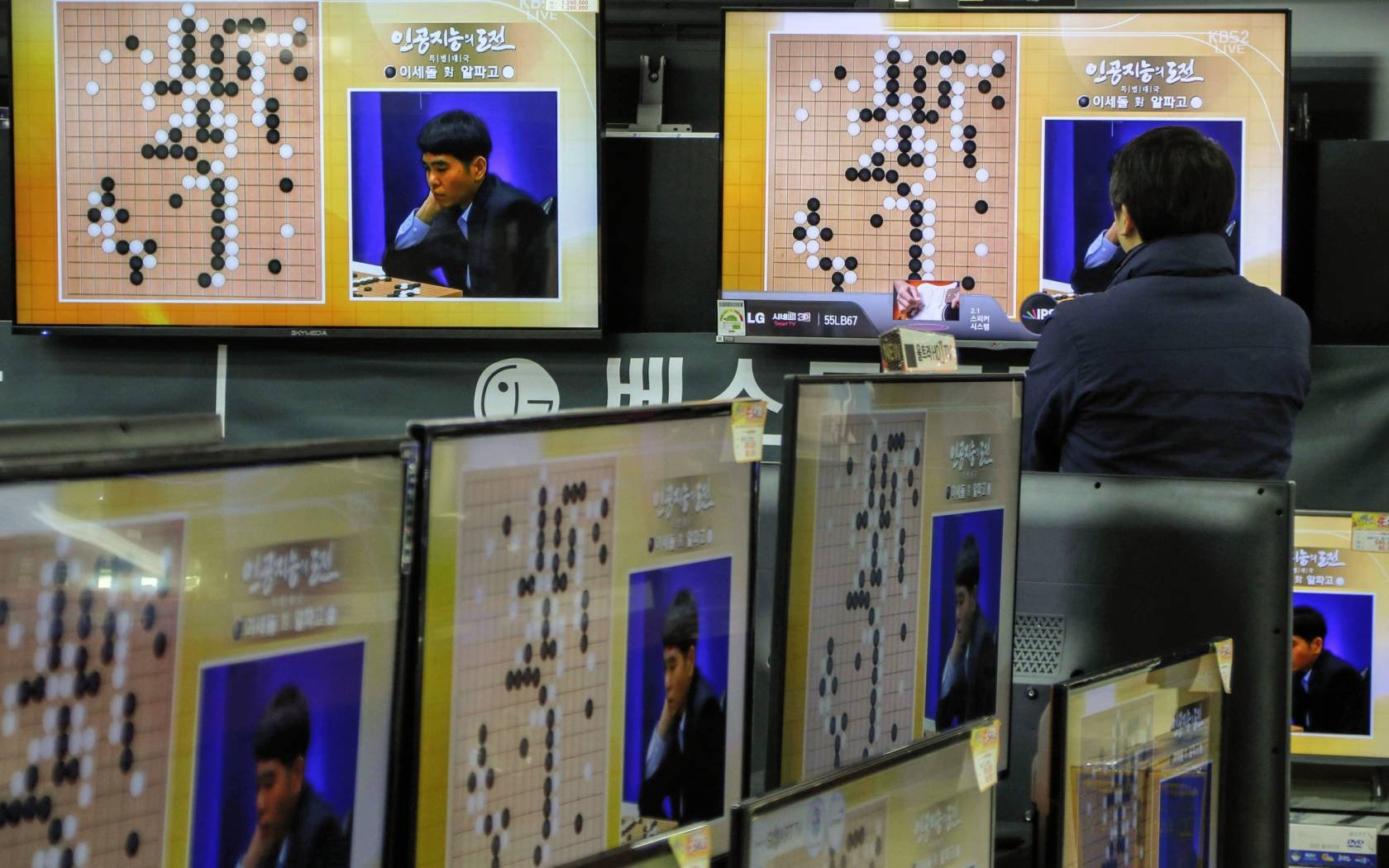 TV screens showing the live broadcast of the Google DeepMind Challenge Match at Yongsan Electronic Technology Land in Seoul, South Korea.