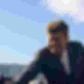 During a campaign trip Senator John F. Kennedy greets a roadside crowd in Indiana.