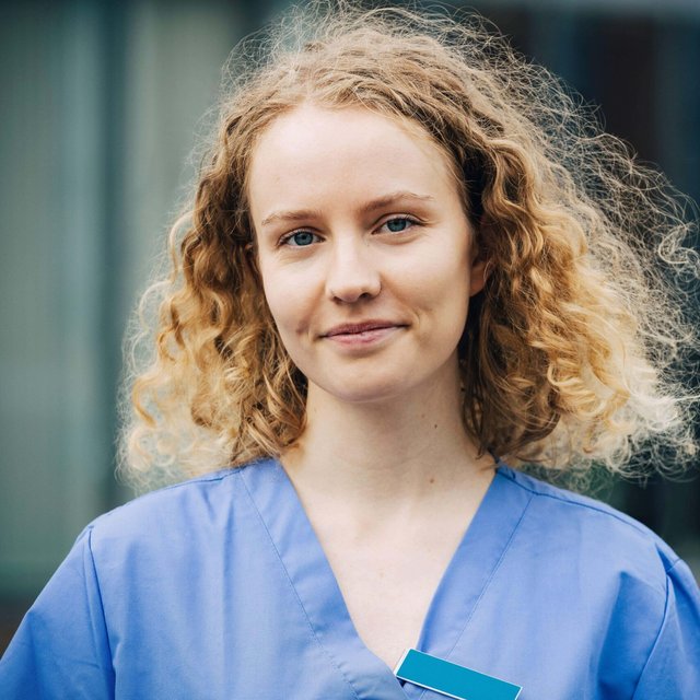 Portrait of smiling female nurse with blond hair