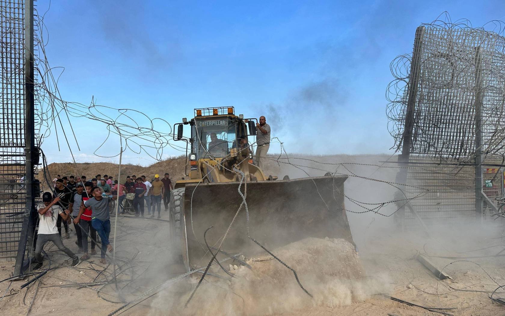 Hamas fighters crossing the border fence with Israel from Khan Yunis in the southern Gaza Strip.