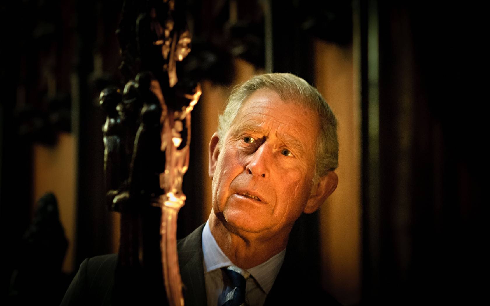 King Charles III views a wooden carving at St. Laurence's Church in Ludlow, Shropshire.