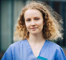 Portrait of smiling female nurse with blond hair