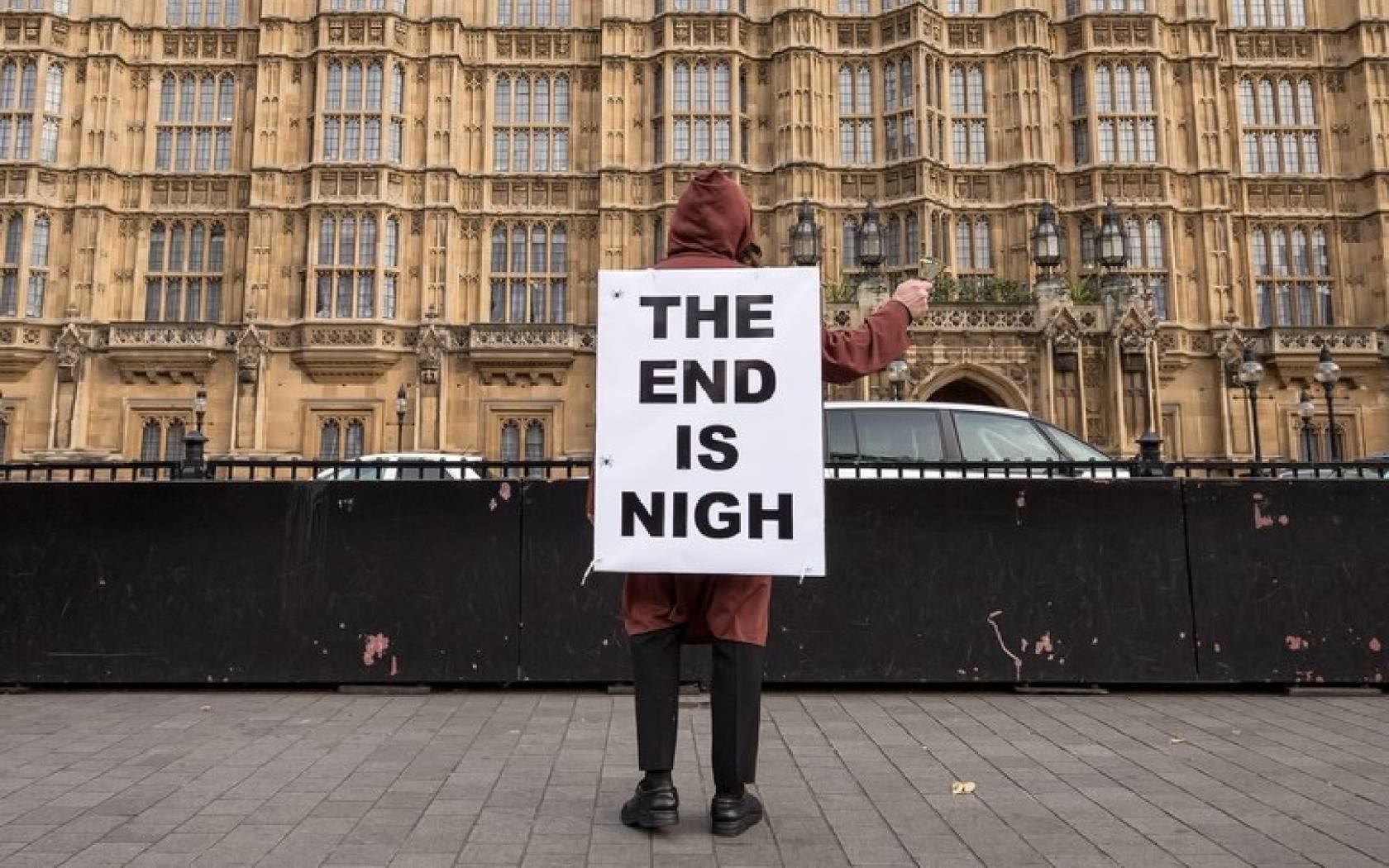 An ‘The End Is Nigh’ apocalyptic sign is seen near Westminster.