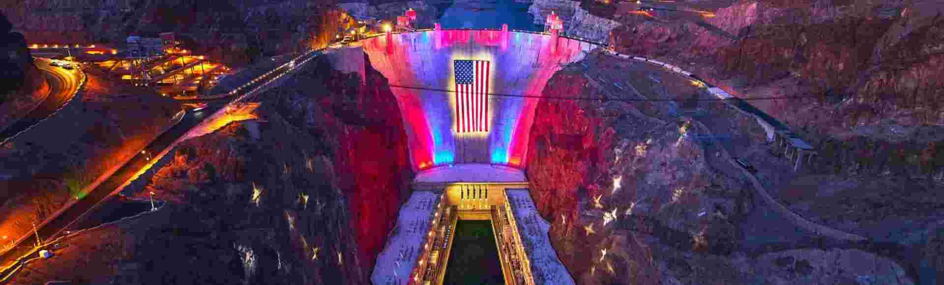 The Hoover Dam in Nevada lit up with the United States flag.