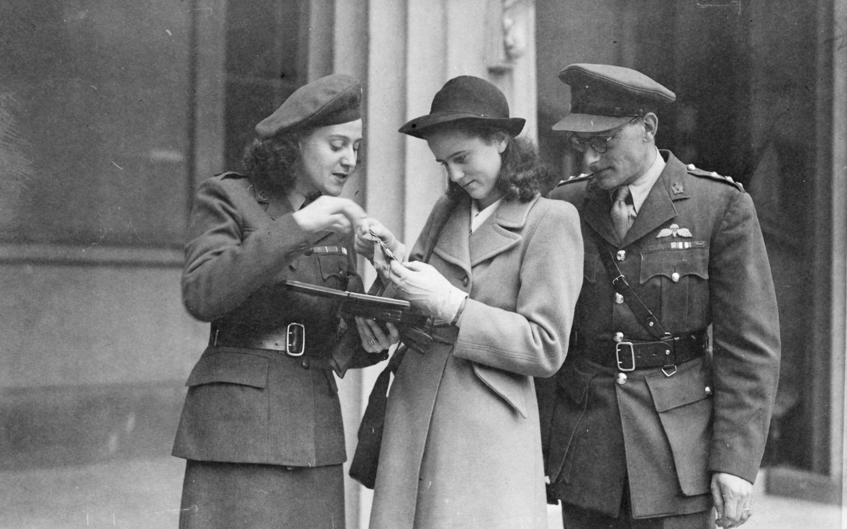 Mrs Odette Sansom showing her George Cross medal to her daughter François after the investiture ceremony at Buckingham Palace, on 19 November 1946.