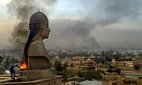 Iraqi protestors set a fire at the base of a statue of Saddam Hussein, April 2003.