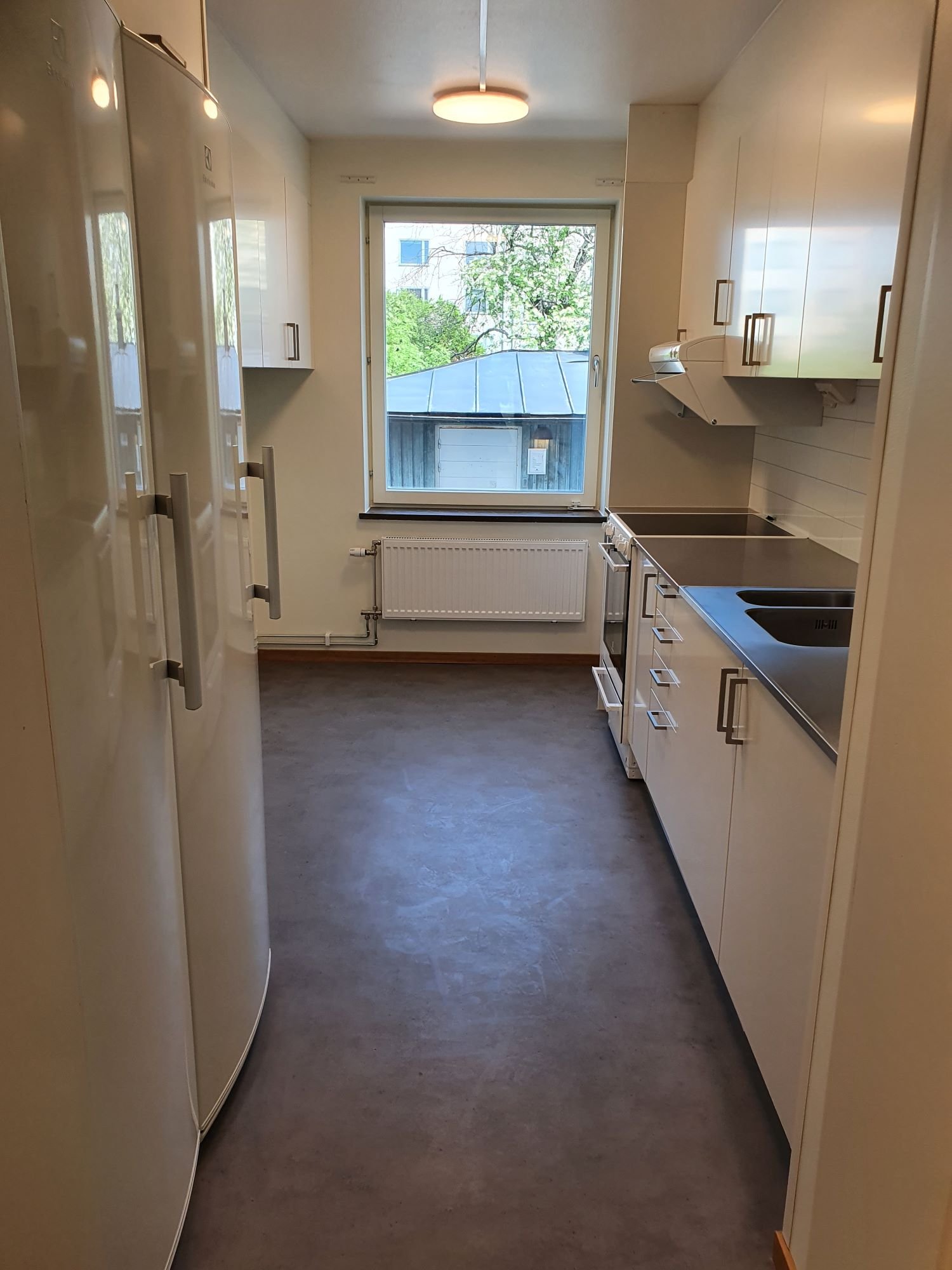 Common kitchen with sink, stove, oven, refrigerator, freezer and cupboards.