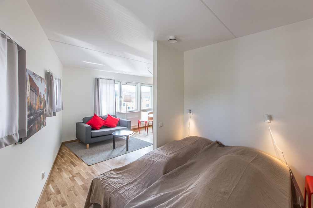 Sleeping alcove with two beds. in the background a couch and coffee table.