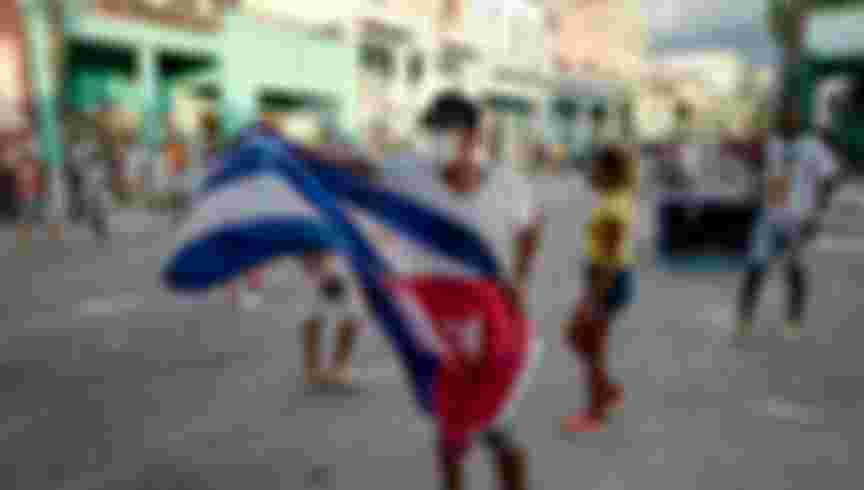 Man waves cuban flag on street