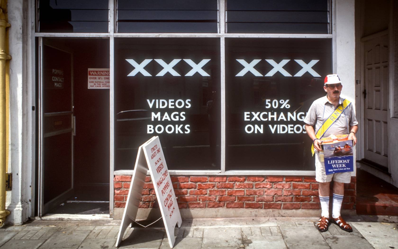 A man raising money for charity outside a sex shop in Brighton, East Sussex.