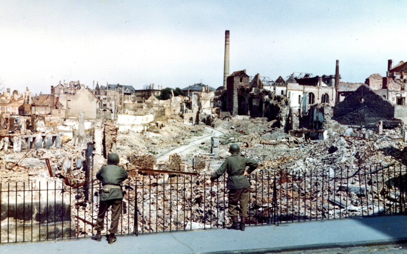 Two American soldiers survey the ruins of Darmstadt