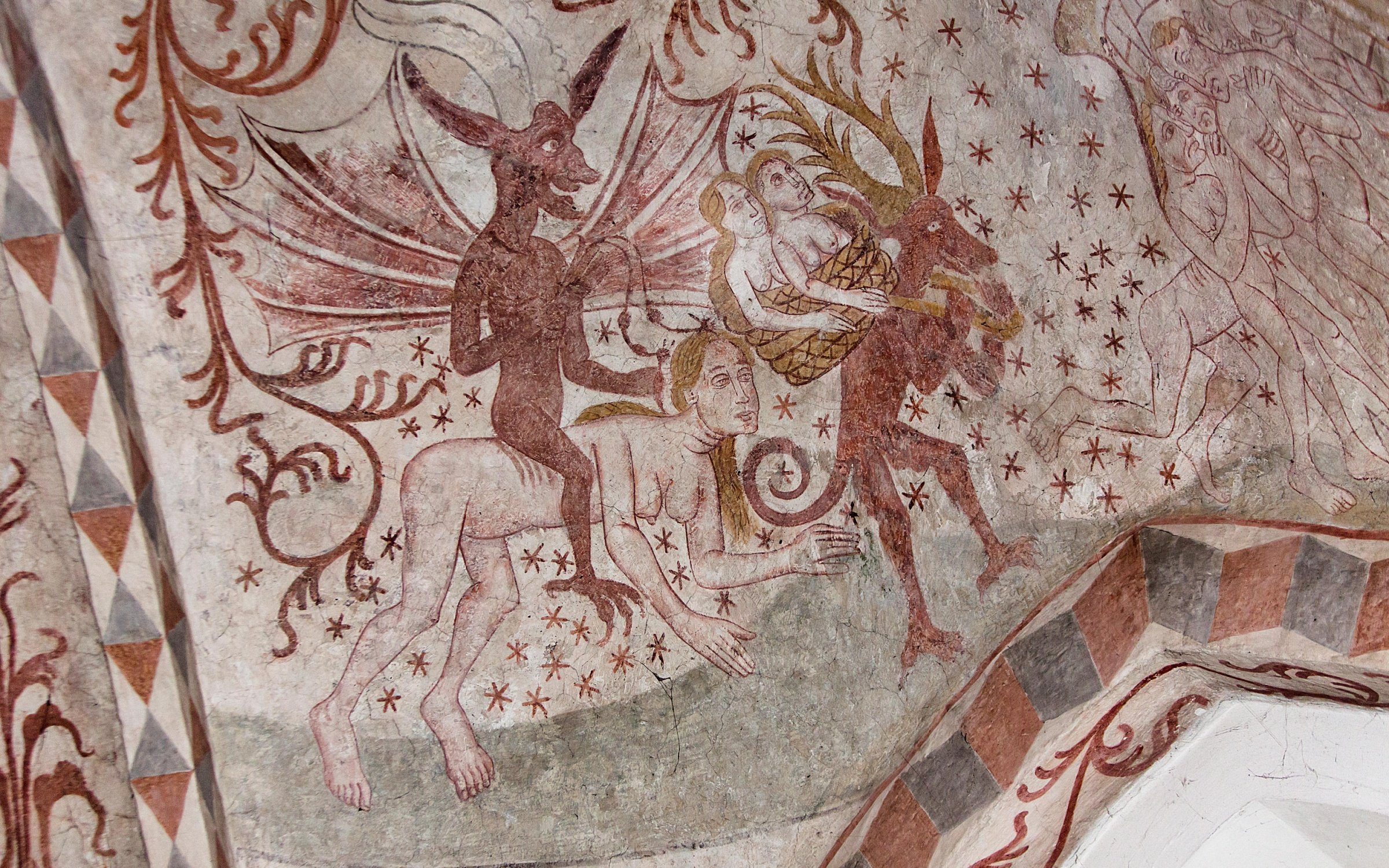A Medieval fresco showing the damned being dragged to Hell.