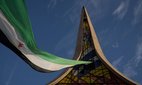 A giant Syrian flag at the Damascene Sword monument in Damascus' Umayyad Square.