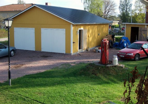 Yellow double entrance with pedestrian side door