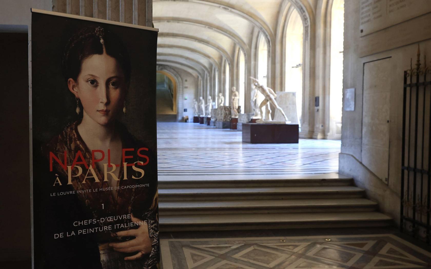 A board promoting the exhibition Naples in Paris is pictured at the Louvre museum in Paris.