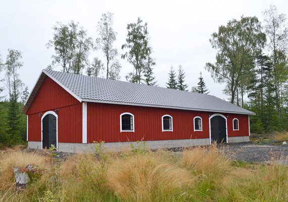 Stallbyggnad med välvda fönster och portar