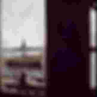 The Statue of Liberty seen through a broken window on Ellis Island.