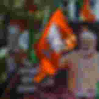 A billboard with an image of Indian Prime Minister Narendra Modi is surrounded by Bharatiya Janata Party (BJP) flags as supporters gather to celebrate election results outside the BJP headquarters in Mumbai in 2019