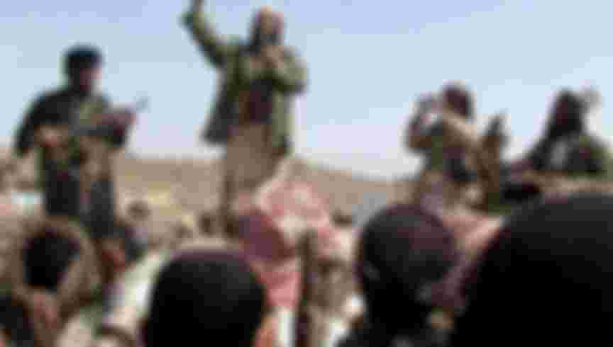 A man claiming to be an Al-Qaeda member addresses a crowd gathered in Yemen's southern province of Abyan on December 22, 2009. Men claiming to be Al-Qaeda members have vowed to avenge those killed in a Yemeni air strike on one of the group's training camps in southern Yemen, Al-Jazeera television reported. In a short video aired by the pan-Arab satellite channel, a bearded man holding a microphone and flanked by two armed men addressed a crowd gathered in the Abyan province to mourn those killed in the December 17 air raid. AFP PHOTO/STR == BEST QUALITY AVAILABLE == (Photo credit should read -/AFP via Getty Images)