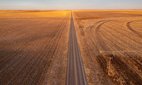 US Highway 64 runs between farms in the Oklahoma panhandle.