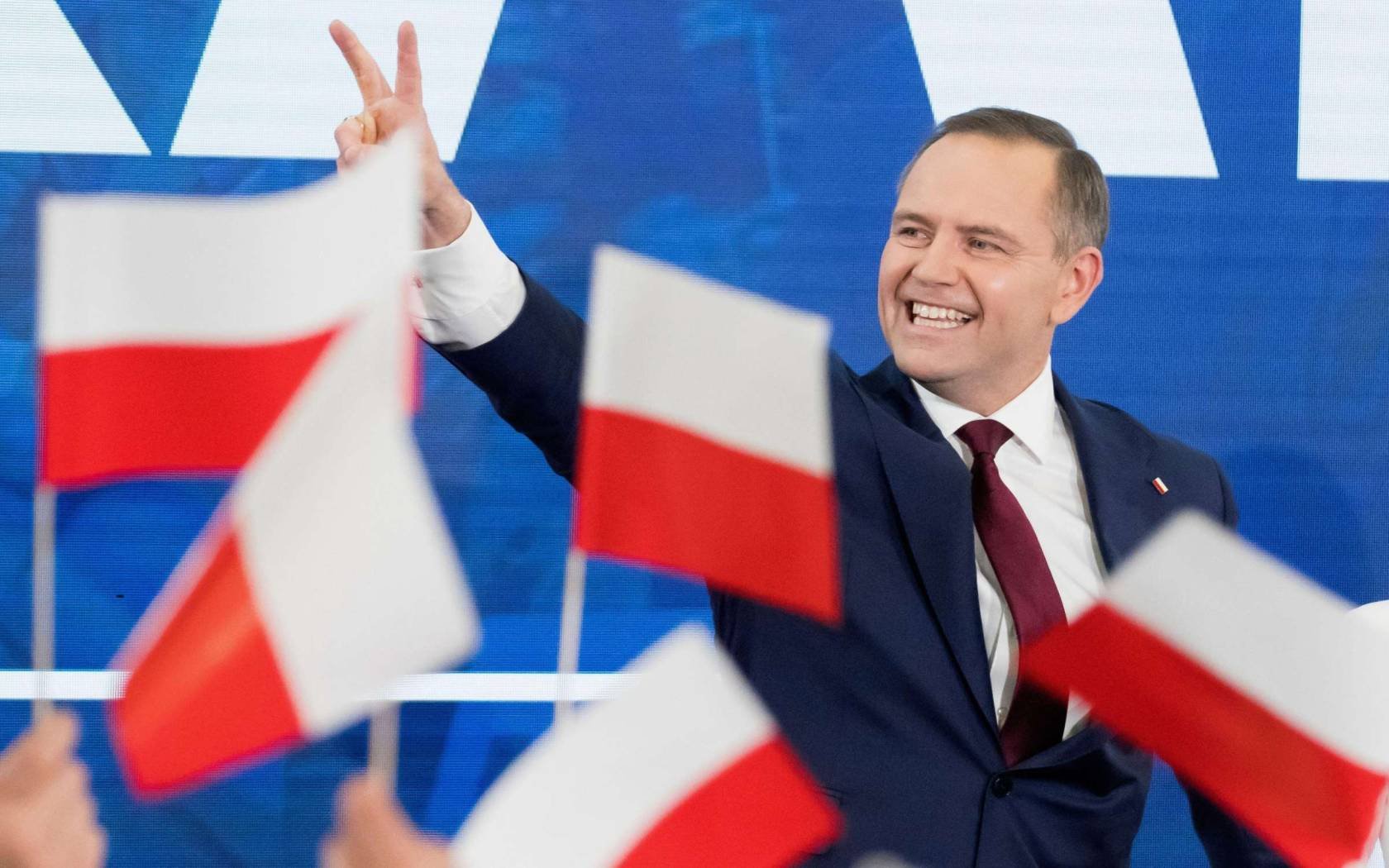 Karol Nawrocki waves to supporters in Gdánsk on 18 May 2025.