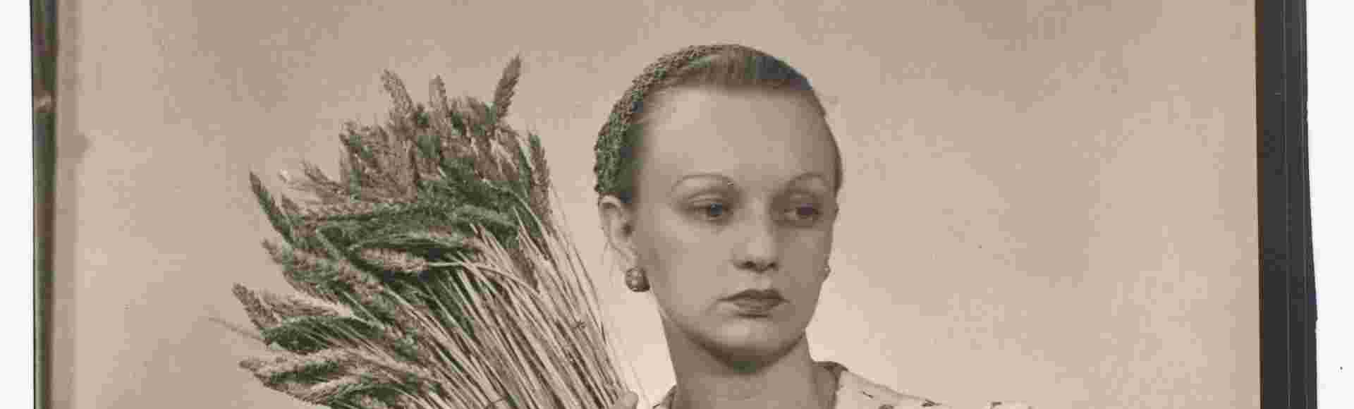 Portrait of Ithell Colquhoun holding a bundle of a wheat taken by Man Ray