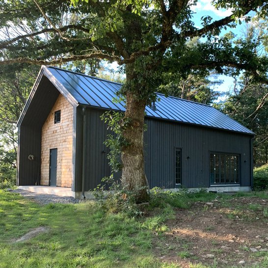 Dark finish single family residence with overhang facade detail