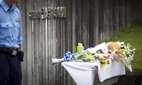 A flower and offering is seen in front of the entrance of the Tsukui Yamayuri-en building at Sagamihara.