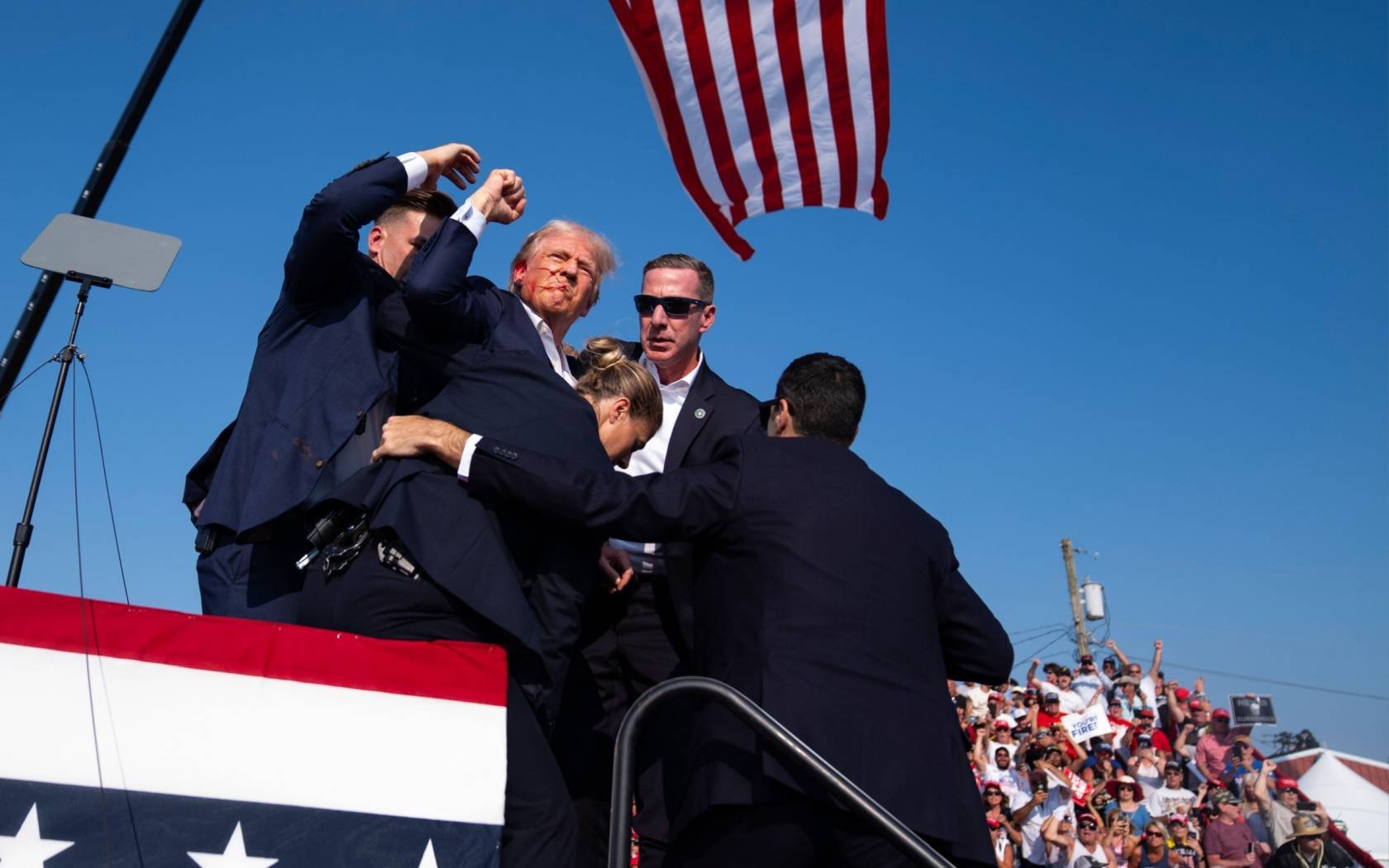 Republican presidential candidate Donald Trump is pulled off stage after shots are fired at a rally in Pennsylvania, 13 July 2024.