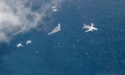 Two US Air Force B-2 Spirits fly alongside four Royal Australian Air Force EA-18G Growlers and a RAAF E-7A Wedgetail, August 2022.