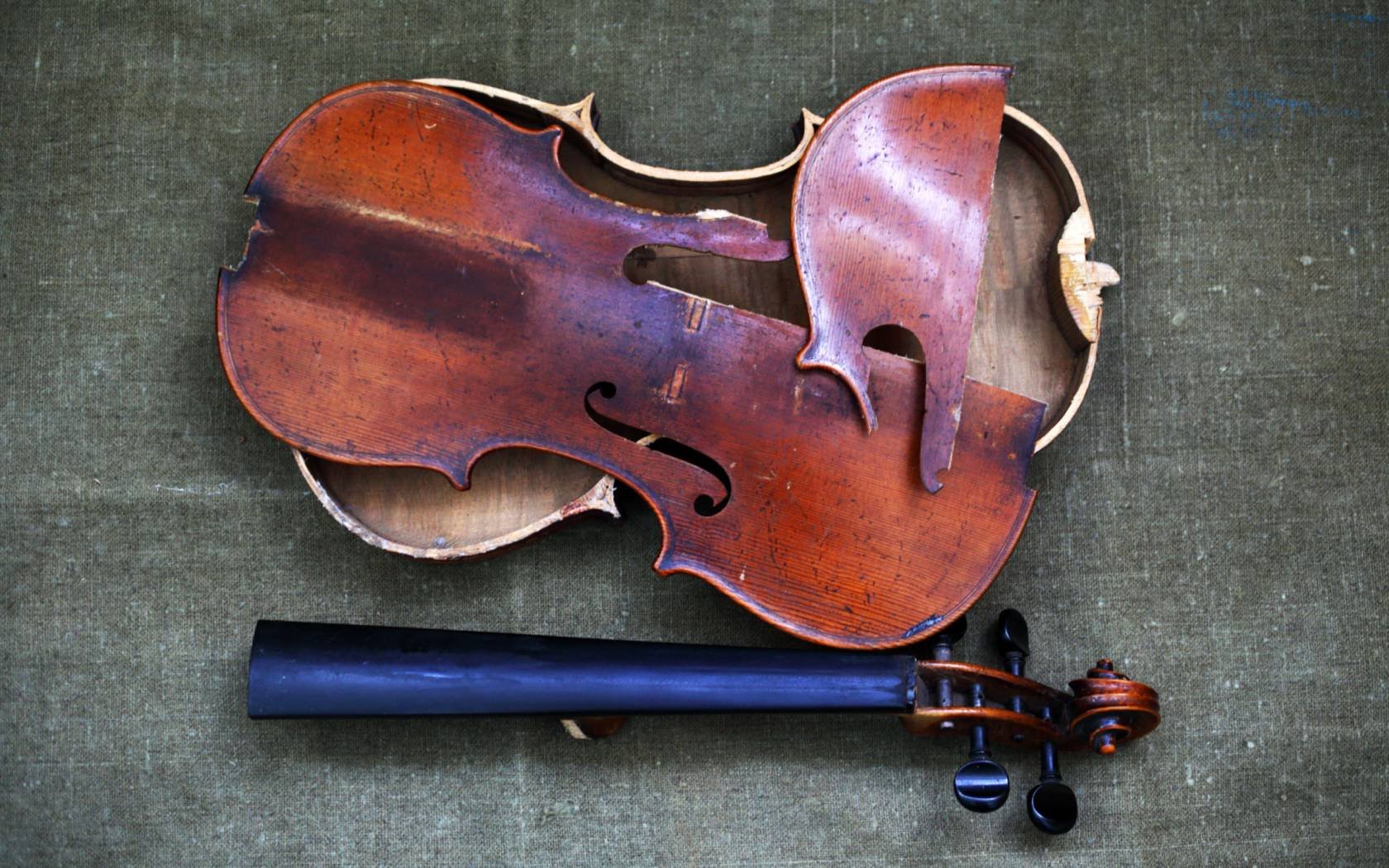 A broken violin awaiting repair.
