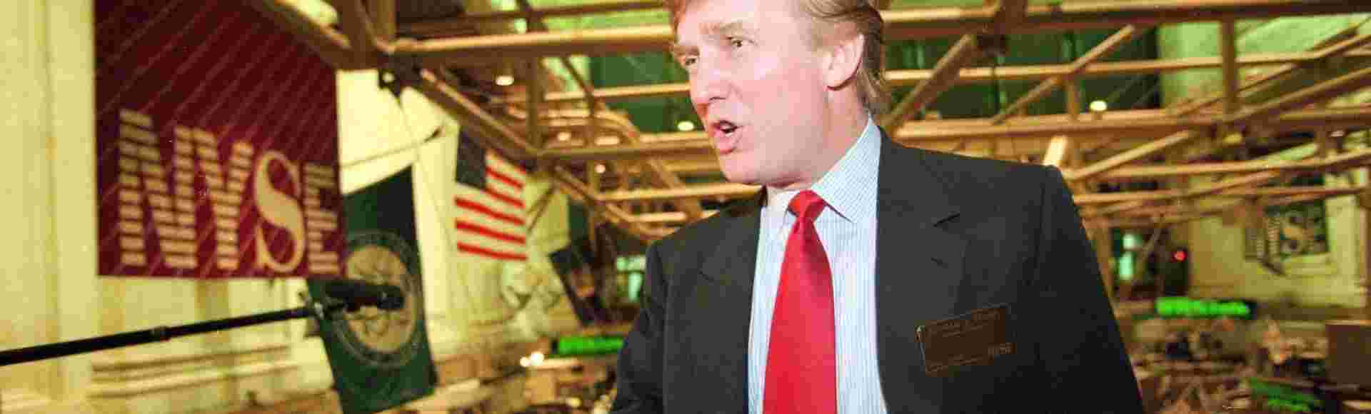 Donald Trump poses for photos above the floor of the New York Stock Exchange after taking his Trump Plaza Casino public in New York on June 7, 1995.
