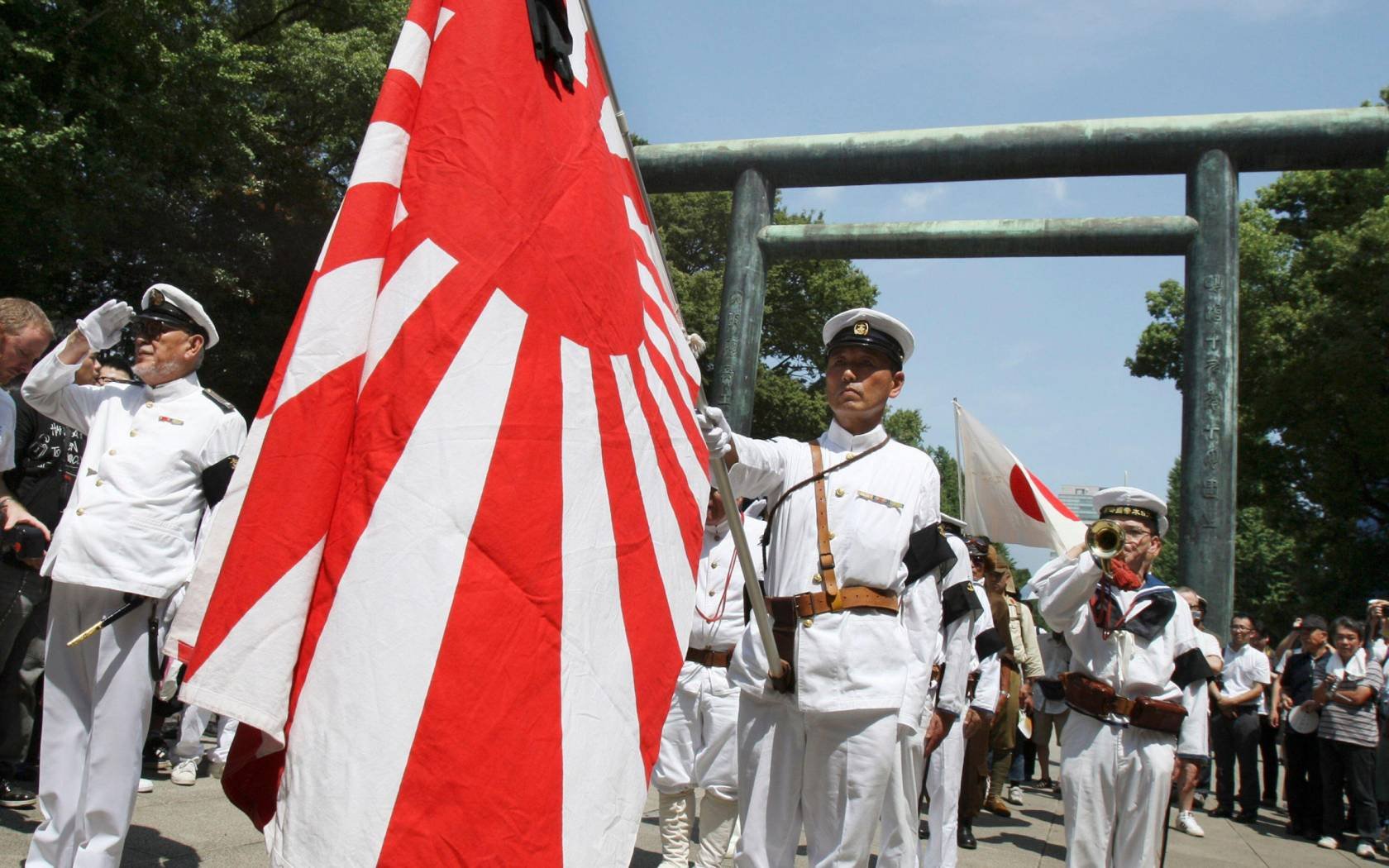 Japanese Imperial Navy veterans and costumed men march at the Yasukuni Shrine. Tokyo, Japan.