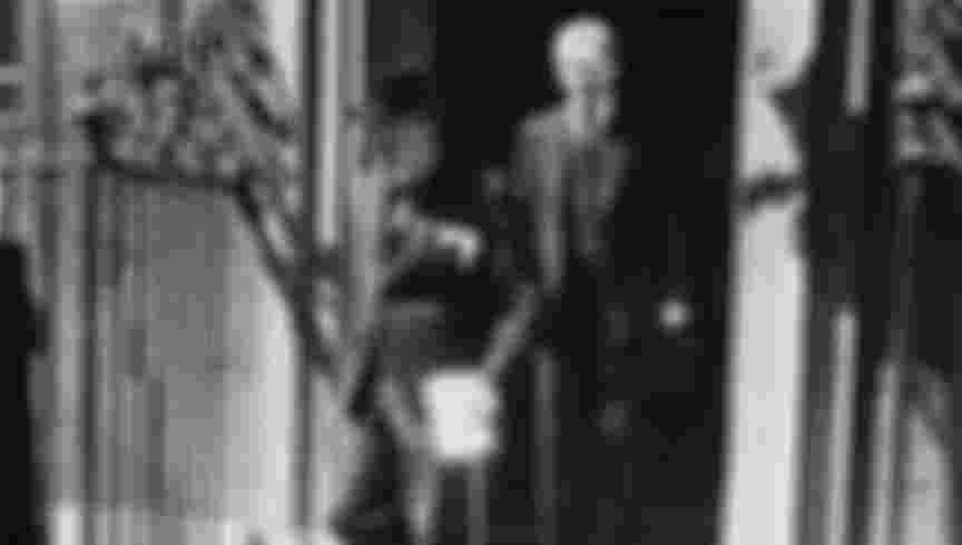 British Prime Minister Winston Churchill leaves Number 10 Downing Street to make his statement in the House of Commons on the capitulation of France during World War Two. Behind him is Parliamentary Private Secretary Brendan Bracken (1901-1958).