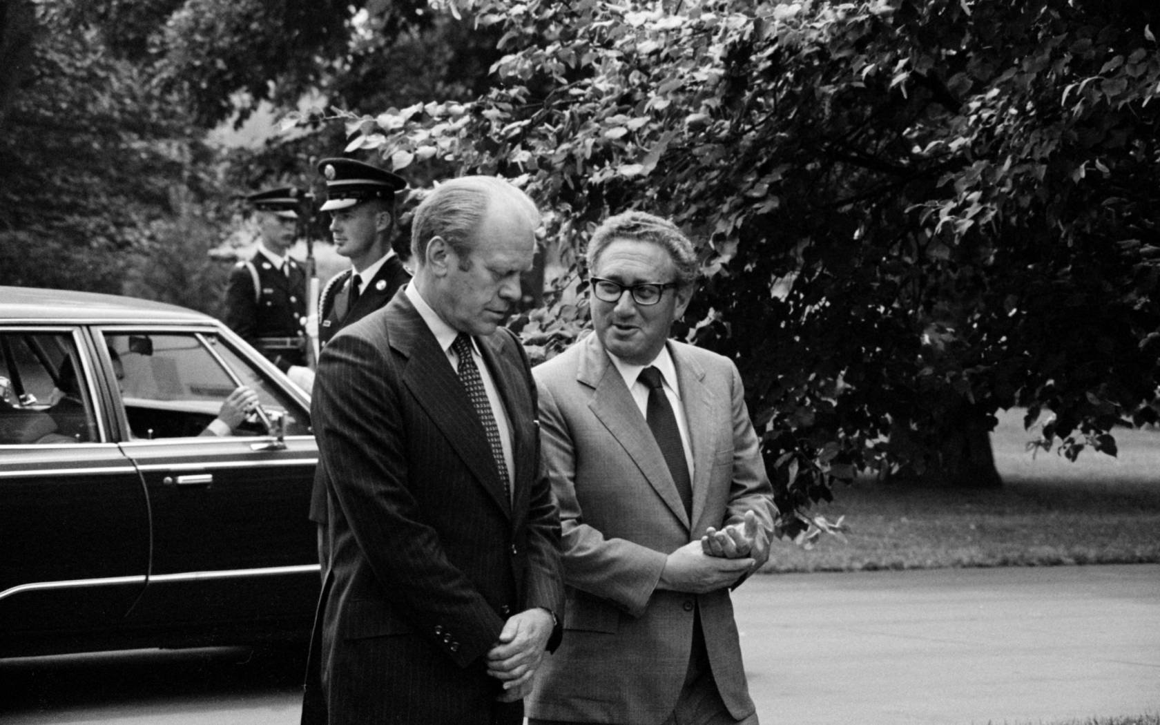 President Gerald Ford and U.S. Secretary of State Henry Kissinger conversing in the grounds of the White House in 1974.